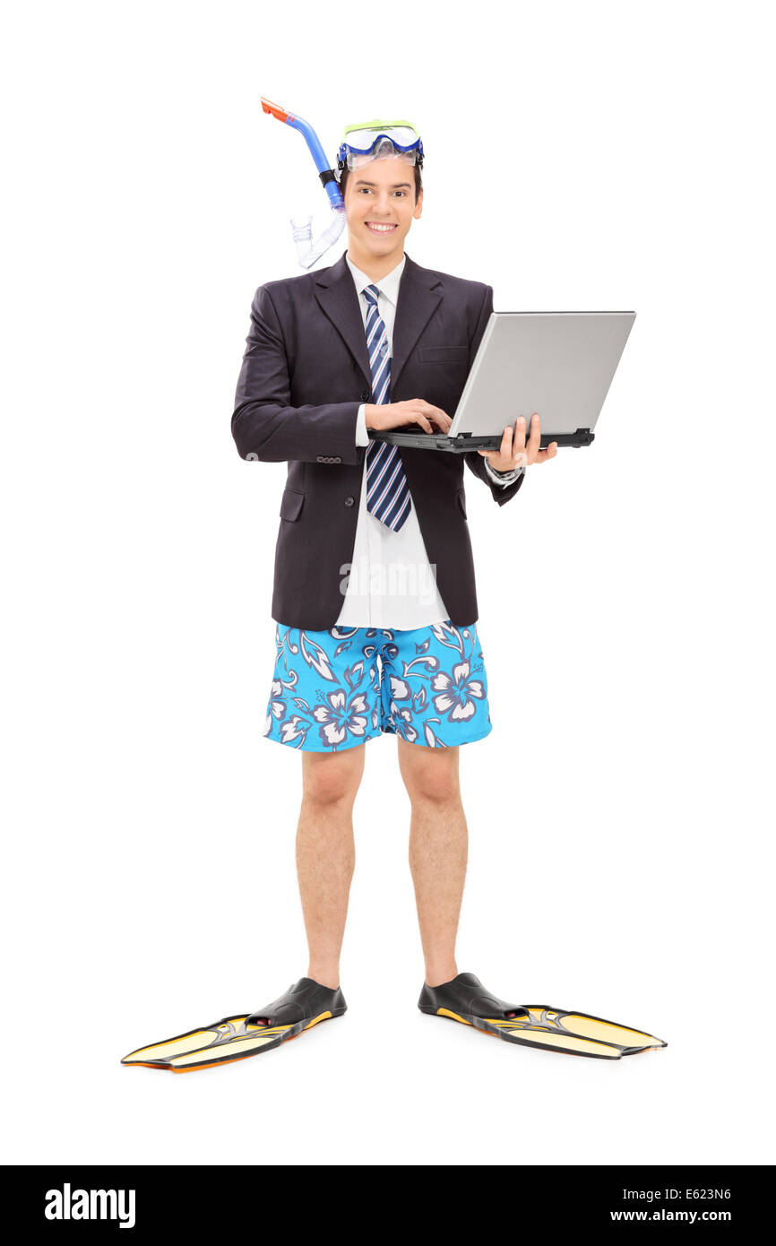 Full length portrait of a businessman with diving equipment holding laptop Stock Photo