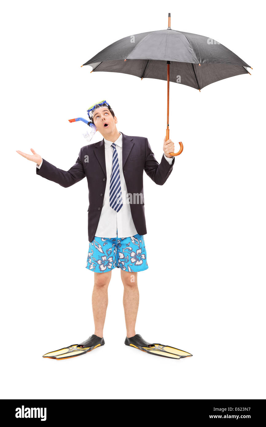Full length portrait of a businessman with diving mask holding an umbrella Stock Photo