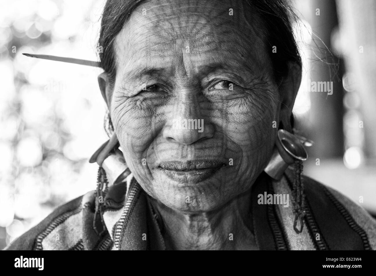 Woman with a traditional facial tattoo and ear jewelry, ethnic group of the Chin, ethnic minority, portrait, Rakhine State Stock Photo