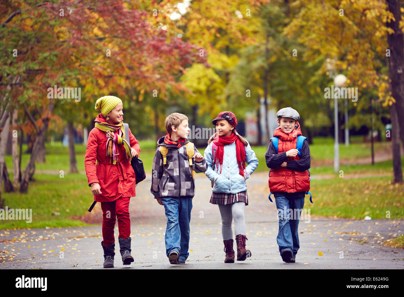 Portrait of happy schoolkids talking while going to school Stock Photo