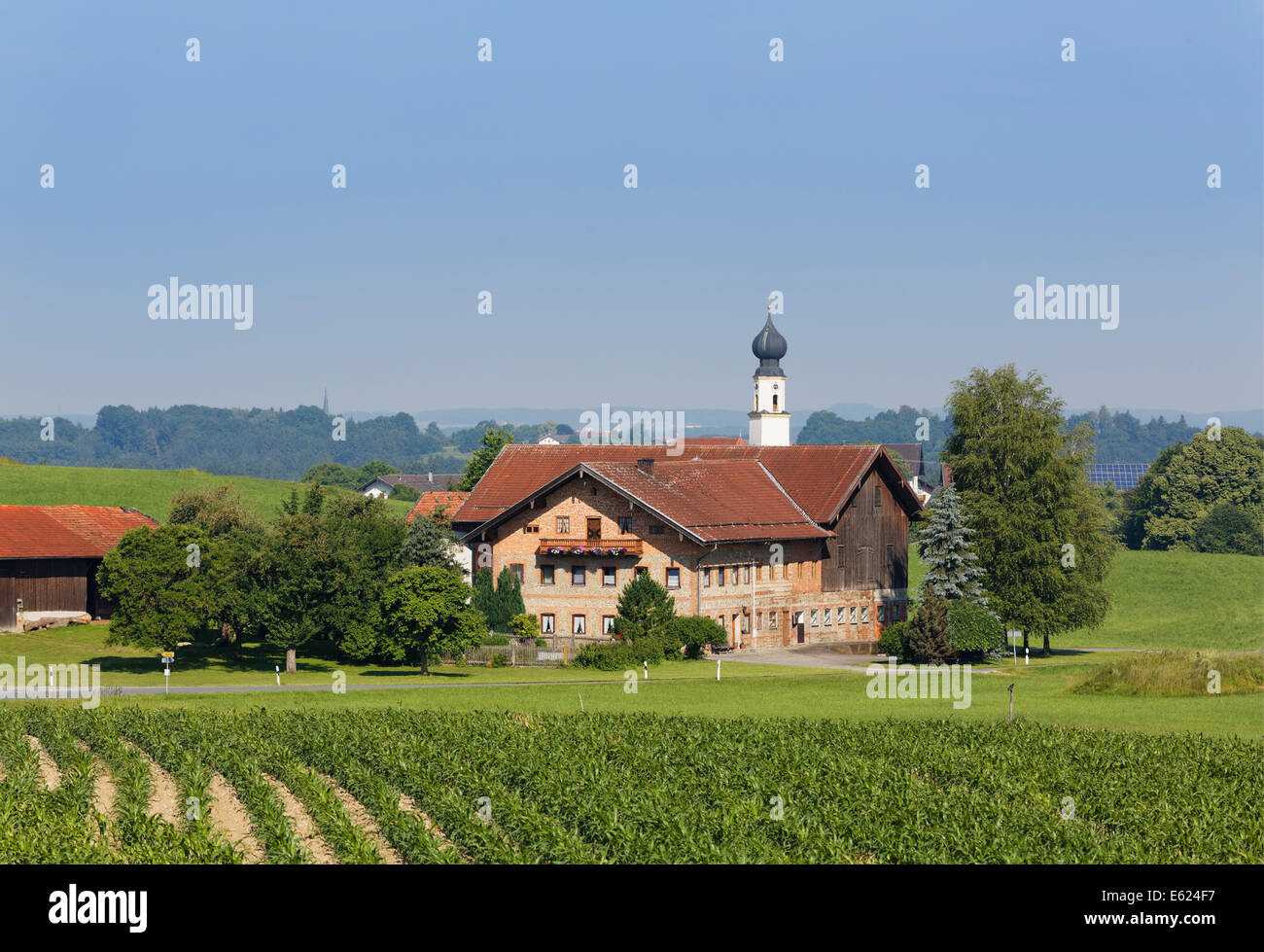 Church in Schonstett with Schwöll estate, Chiemgau, Upper Bavaria, Bavaria, Germany Stock Photo