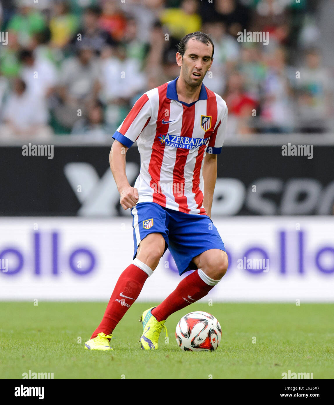 Wolfsburg, Germany. 10th Aug, 2014. Madrid's Diego Godin in action during the soccer test match between VfL Wolfsburg and Atletico Madrid at Volkswagen Arena in Wolfsburg, Germany, 10 August 2014. Photo: Thomas Eisenhuth/dpa/Alamy Live News Stock Photo
