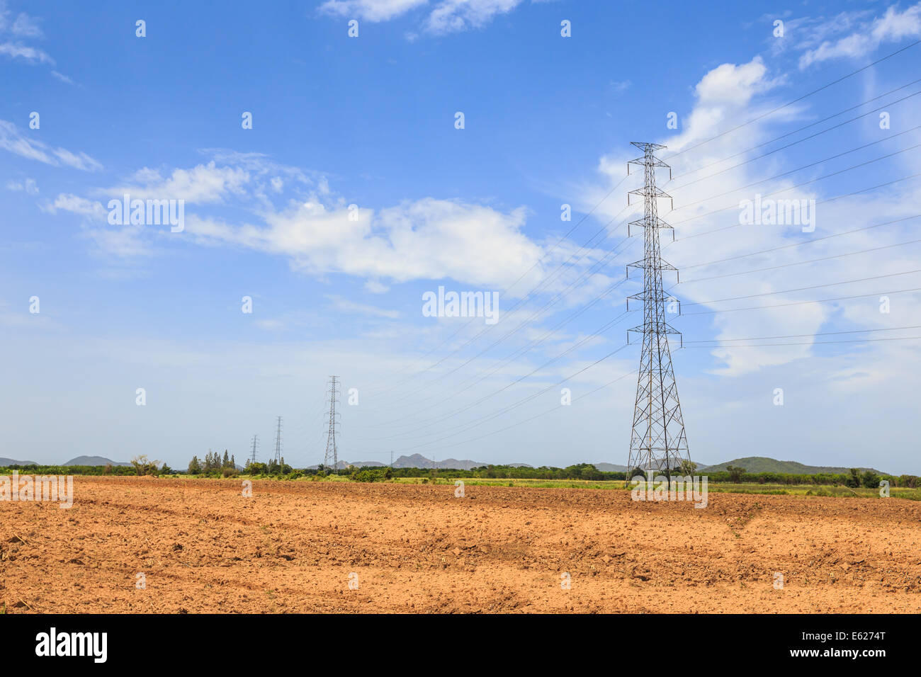 Electricity transmission pylons with blue sky Stock Photo