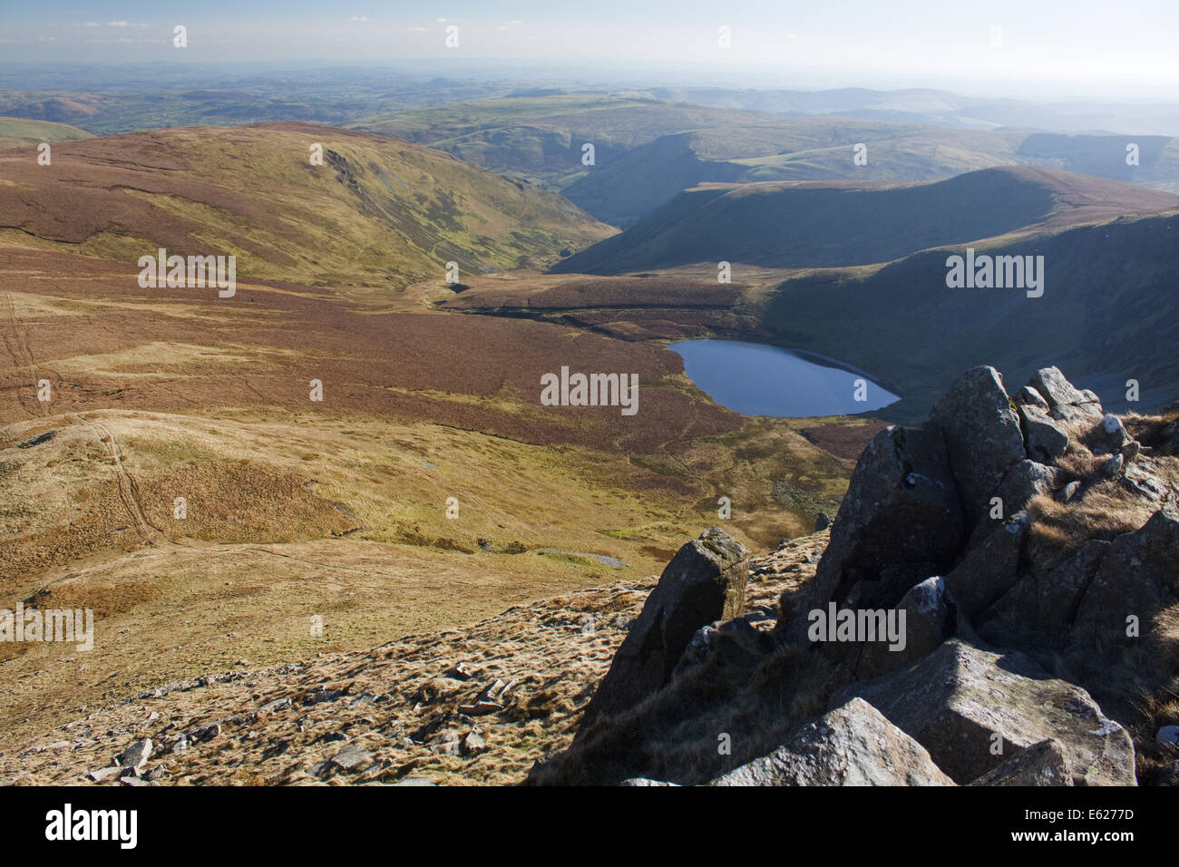 The view of the lake, Llyn Lluncaws, from the summit of Cadair Berwyn in the Berwyn mountains of North Wales Stock Photo