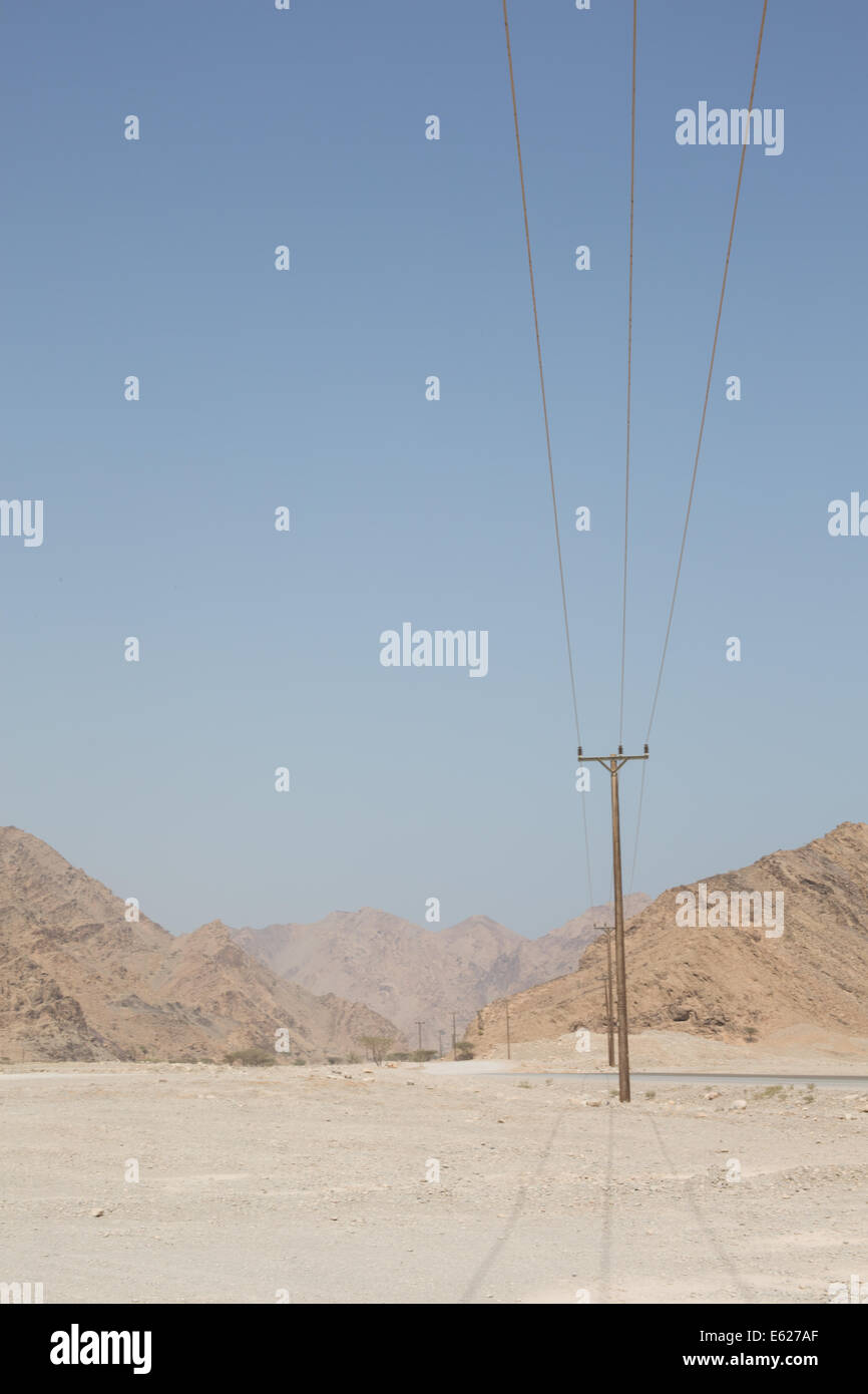 Electricity pylons along the mountainous region, Musandam Peninsula, Oman Stock Photo