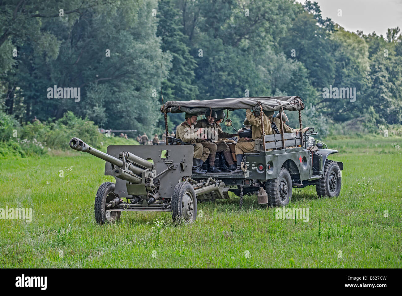 Soviet soldiers transporting a cannon to the battlefield during reenactment of World War II fights Stock Photo