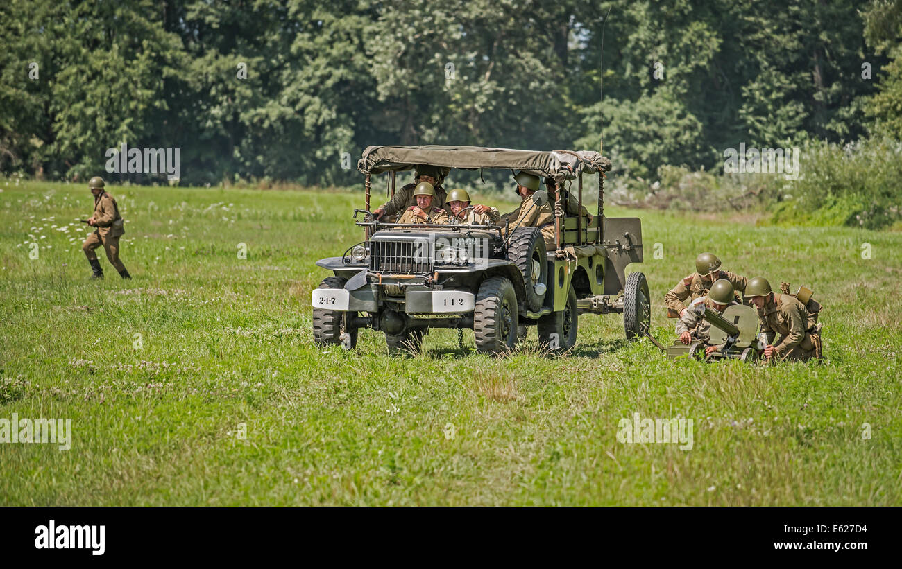 Soviet soldiers preparing a machine-gun for an attack during reenactment of World War II fights Stock Photo