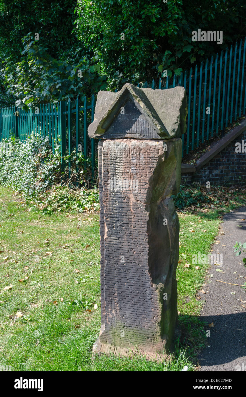 Old stone pillar in the churchyard of St Michael and All Angels church in the historic Staffordshire market town of Penkridge Stock Photo