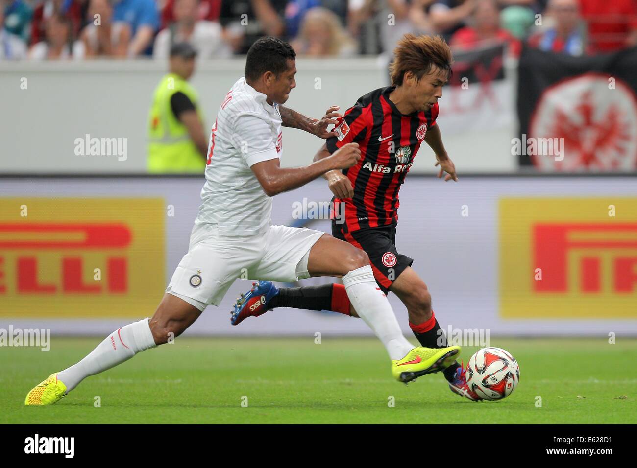 Frankfurt Main, Germany. 10th Aug, 2014. Frankfurt's Takashi Inui (R) and Milan's Fredy Guarin (L) in action during the soccer test match between Eintracht Frankfurt and Inter Milan at Commerzbank-Arena in Frankfurt Main, Germany, 10 August 2014. Frankfurt won the match 3-1. Photo: FREDRIK VON ERICHSEN/DPA/Alamy Live News Stock Photo