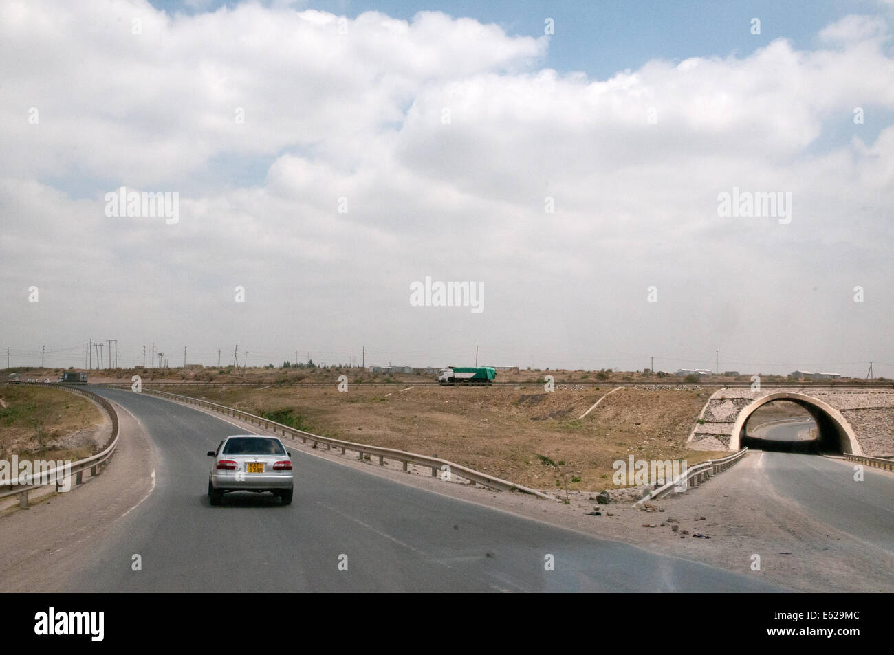 Slip road and underspass tunnel where Namanga Road joins Mombasa Nairobi highway at Athi River Kenya East Africa  MODERN ROAD CA Stock Photo