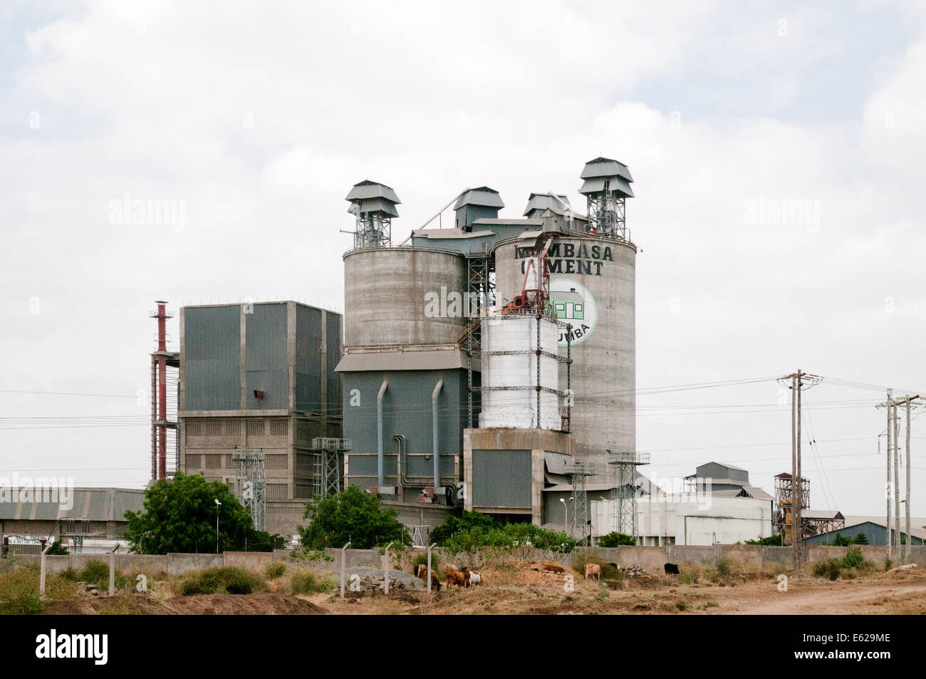 Mombasa Cement industry concrete silo and factory at Athi River seen from Mombasa Nairobi road Kenya East Africa  CEMENT SILO FA Stock Photo