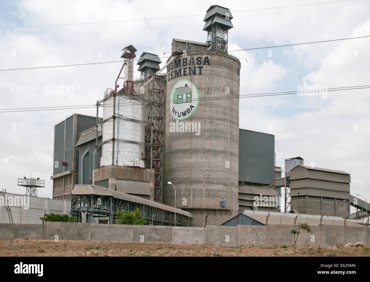 Mombasa Cement industry concrete silo and factory at Athi River seen from Mombasa Nairobi road Kenya East Africa  CEMENT SILO FA Stock Photo