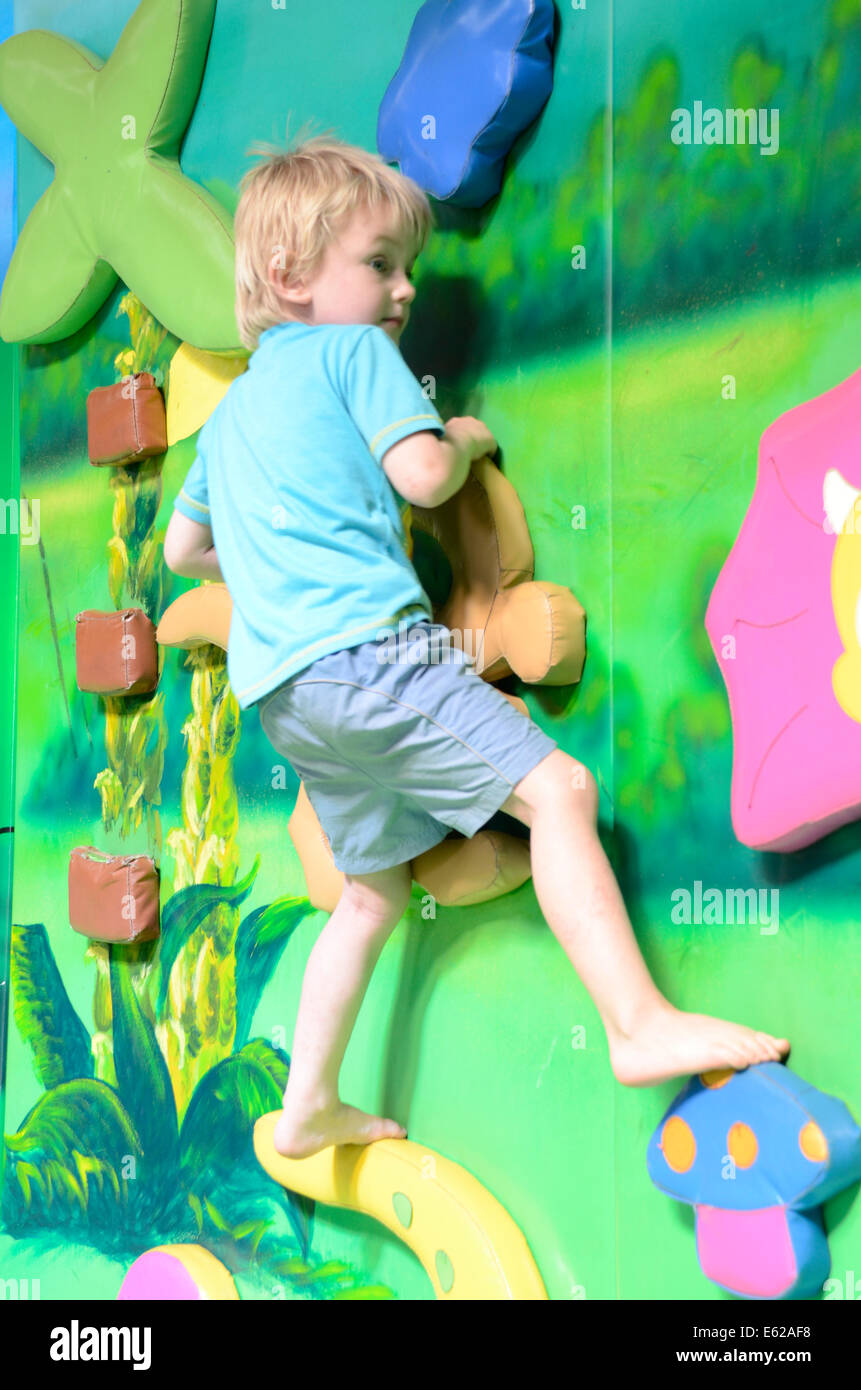 Young boy balancing on indoor climbing Stock Photo Alamy