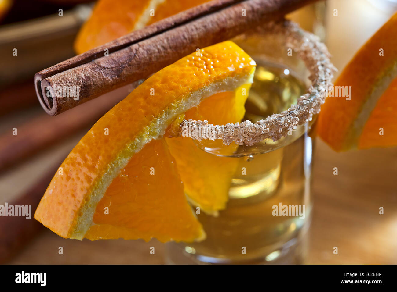 tequila with orange and cinnamon on a wooden table Stock Photo Alamy