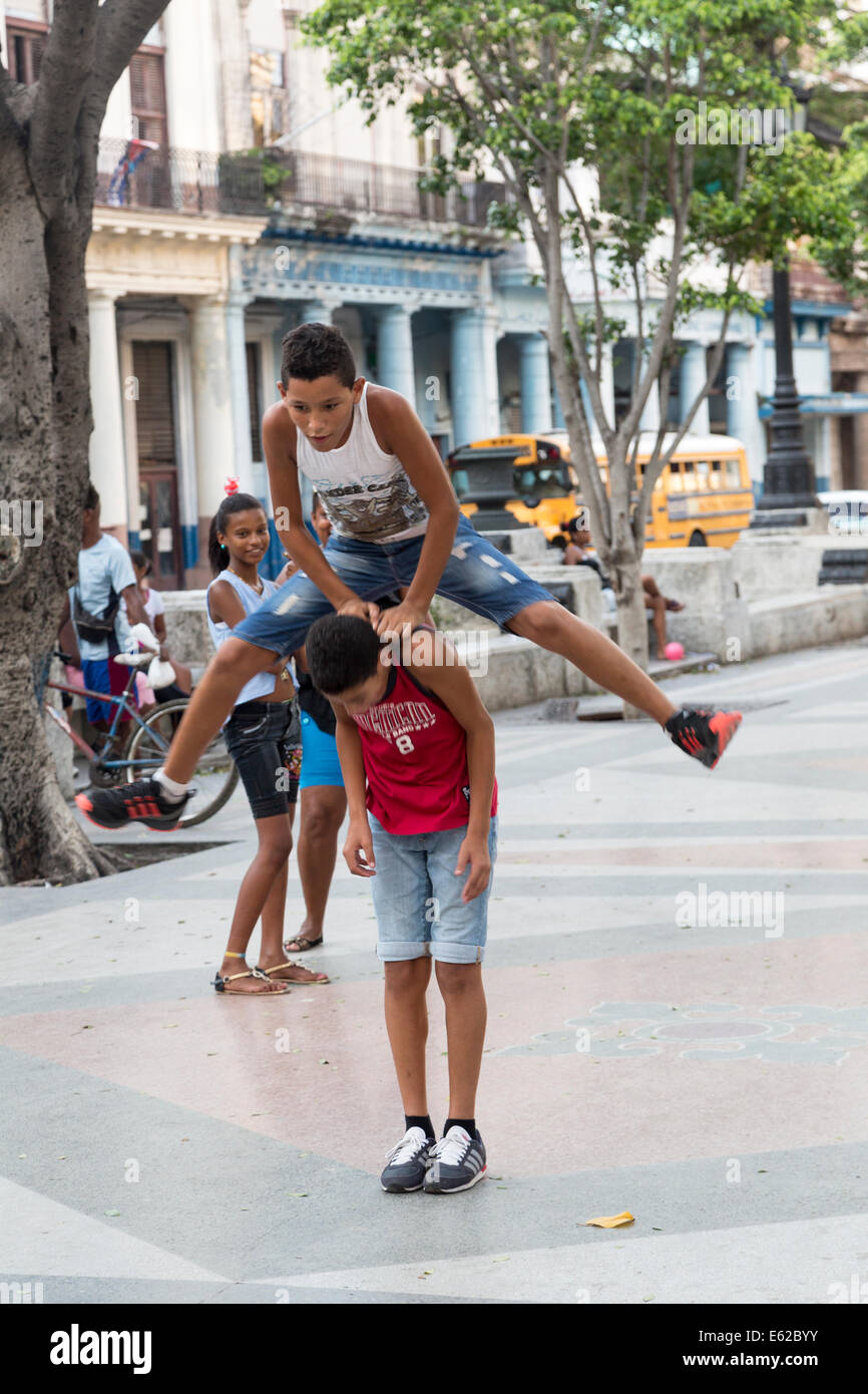 boys playing leapfrog, Paseo del Prado, old Havana, Cuba Stock Photo