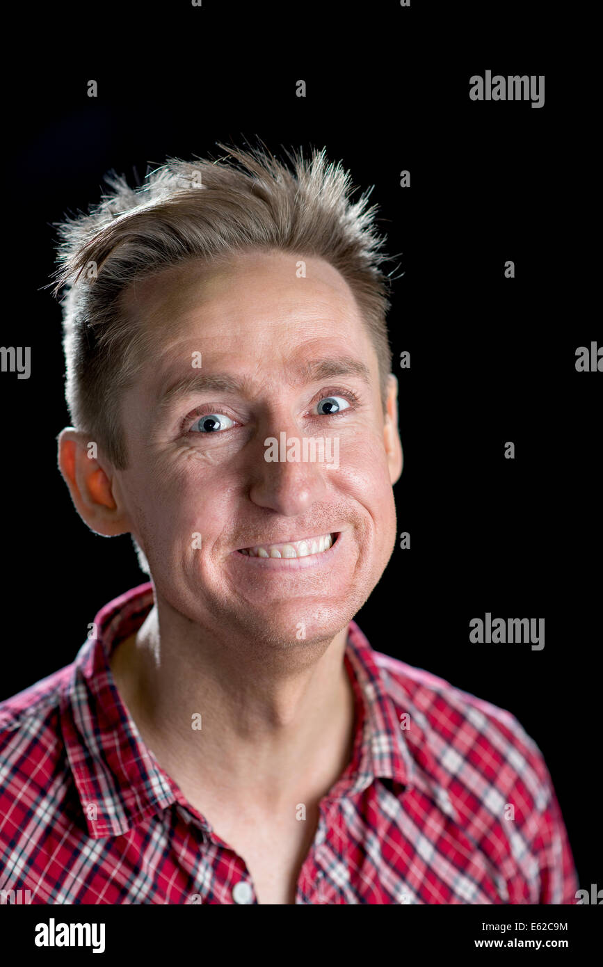 Headshots on black of a good looking man in his thirties with various facial expressions. Stock Photo