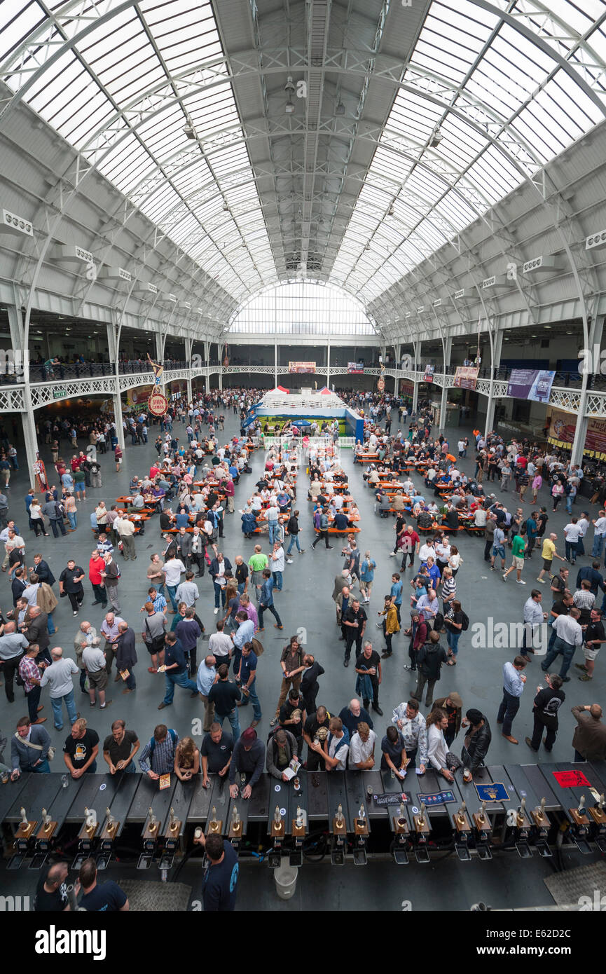 Olympia Exhibition Centre, London, UK. 12th August 2014. The Great British Beer Festival began its 5 day stint at the Olympia exhibition centre in west London. The festival, organised by the Campaign for Real Ale (CAMRA), launched a call to action on the first day which hopes to see 55,000 festival-goers lobbying their MP as the UK pub closure rate rises to an estimated 31 per week. Pictured: An elevated view of Olympia and punters enjoying The Great British Beer Festival. Credit:  Lee Thomas/Alamy Live News Stock Photo