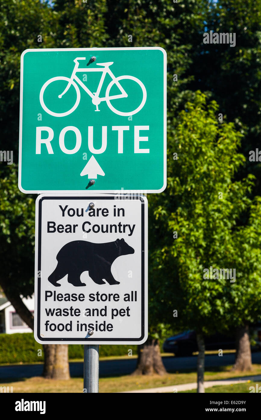Combination of signs advising a bike route and a bear warning in Hope, British Columbia, Canada Stock Photo