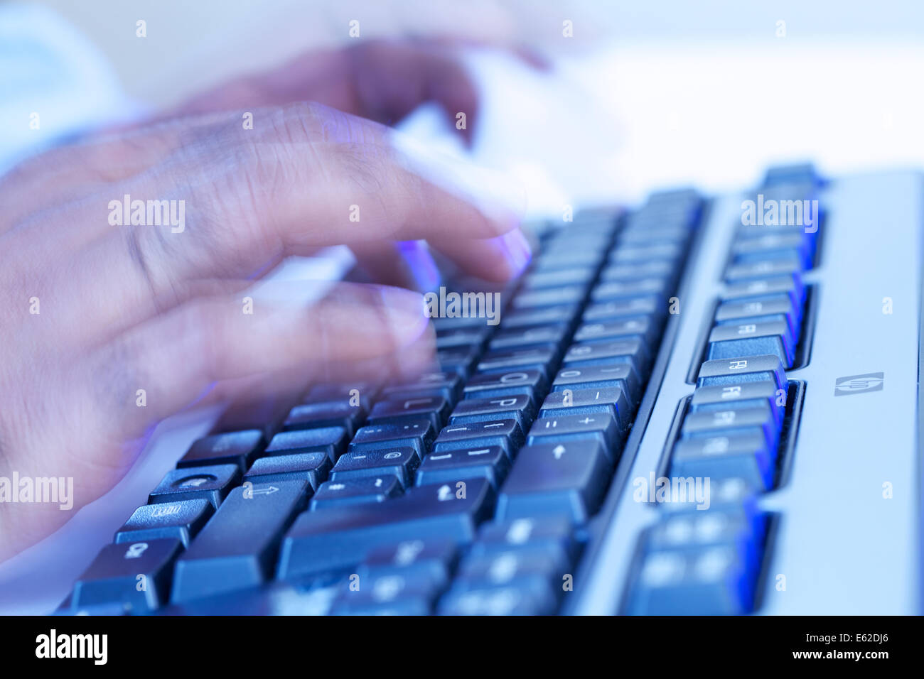 hands of black male typing on modern pc keyboard close up Stock Photo