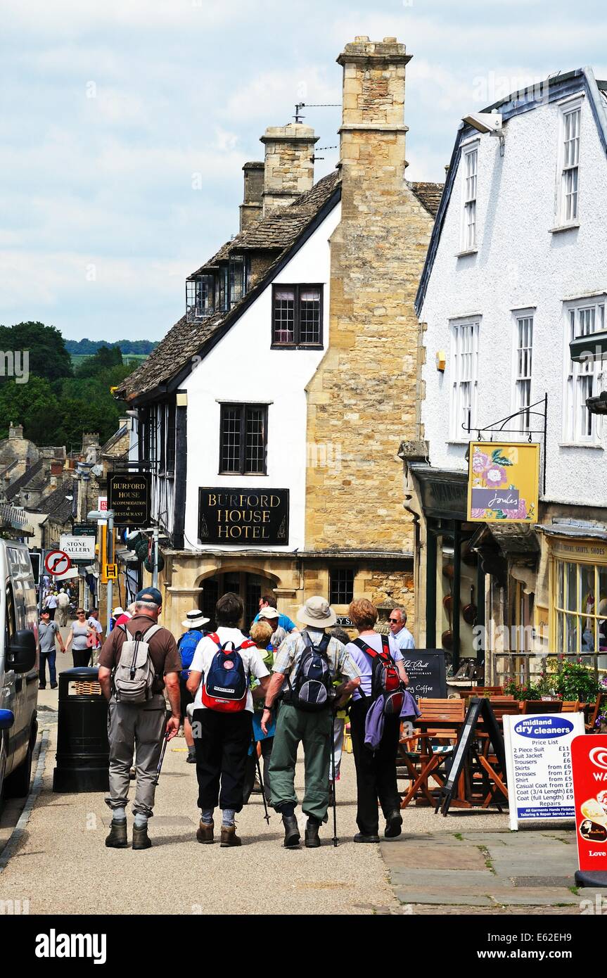 Group of walkers along the High Street, Burford, Oxfordshire, England