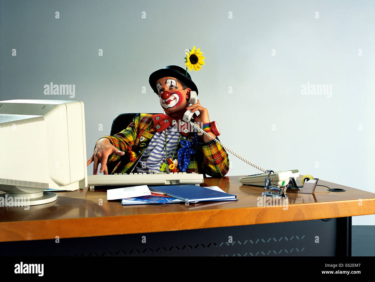 The office clown at computer desk and computer Stock Photo - Alamy