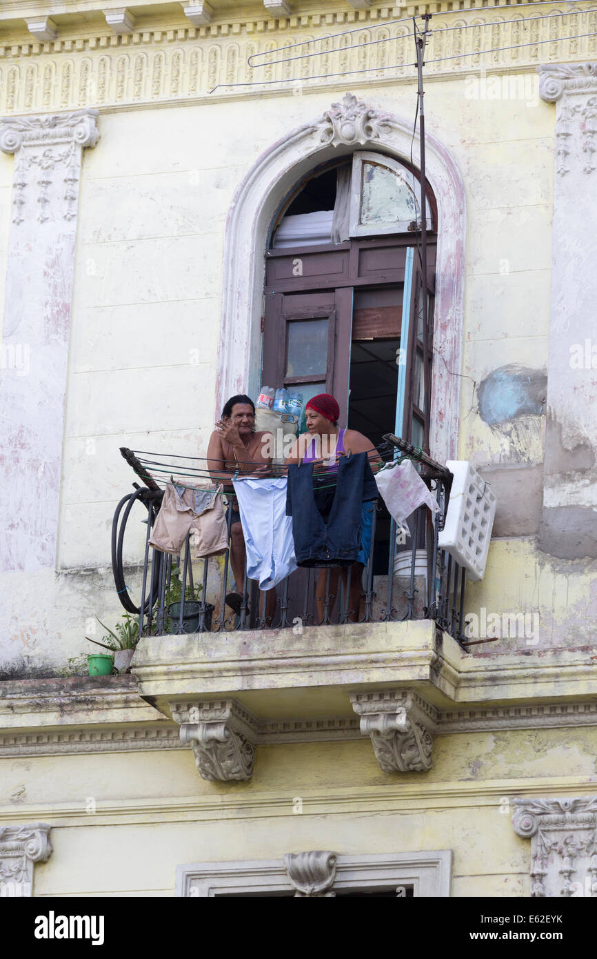 man and woman on balcony, Central Havana, Cuba Stock Photo