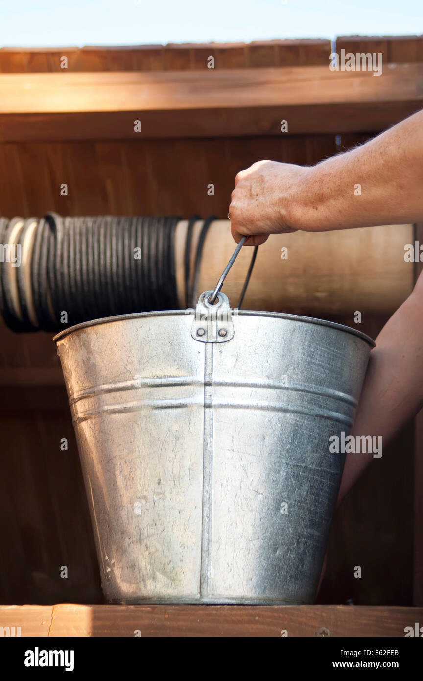 Hand with a Bucket Stock Photo Alamy
