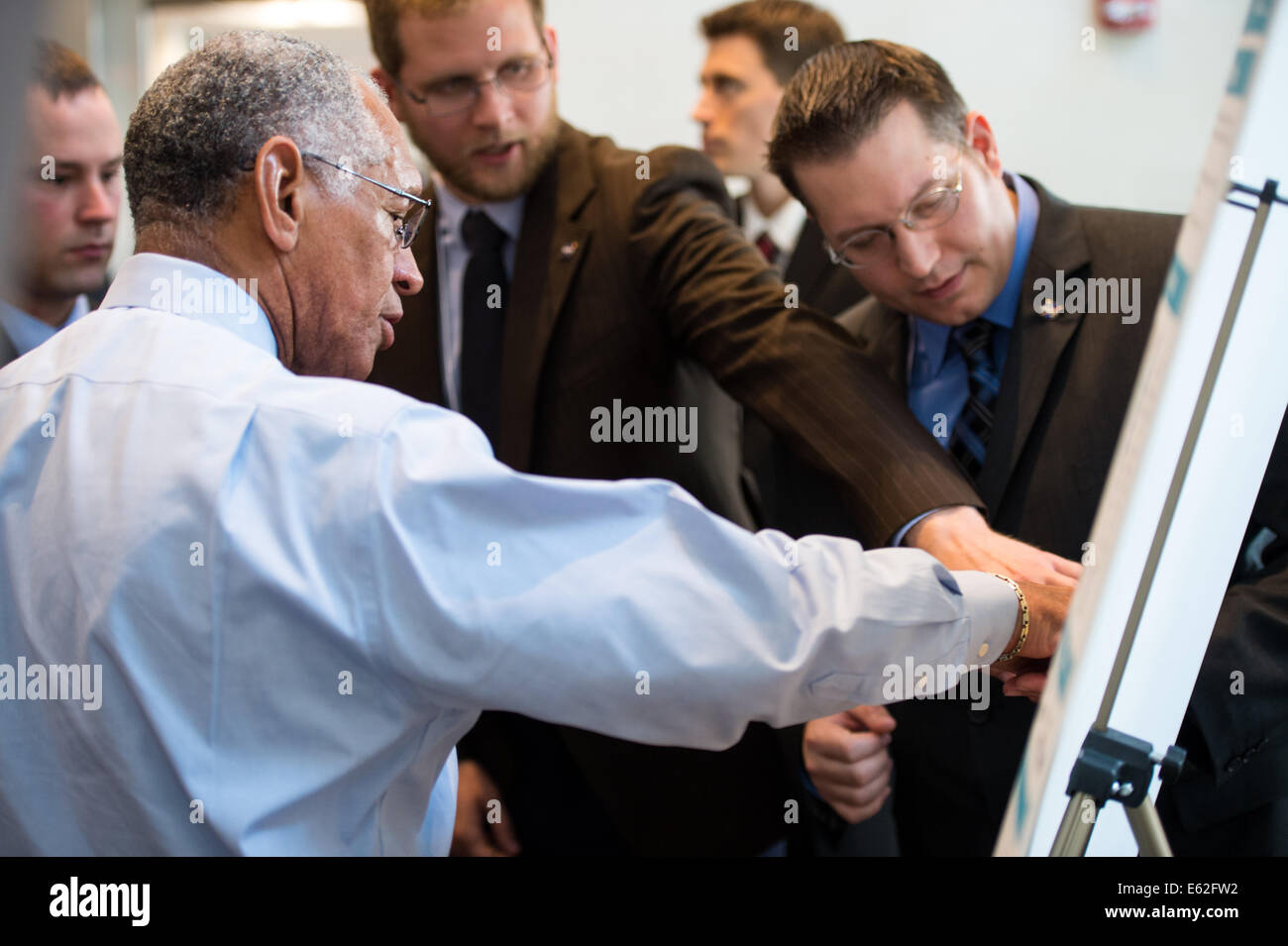 NASA Administrator Charles Bolden speaks with young professionals about their project on New England water resources during the Stock Photo
