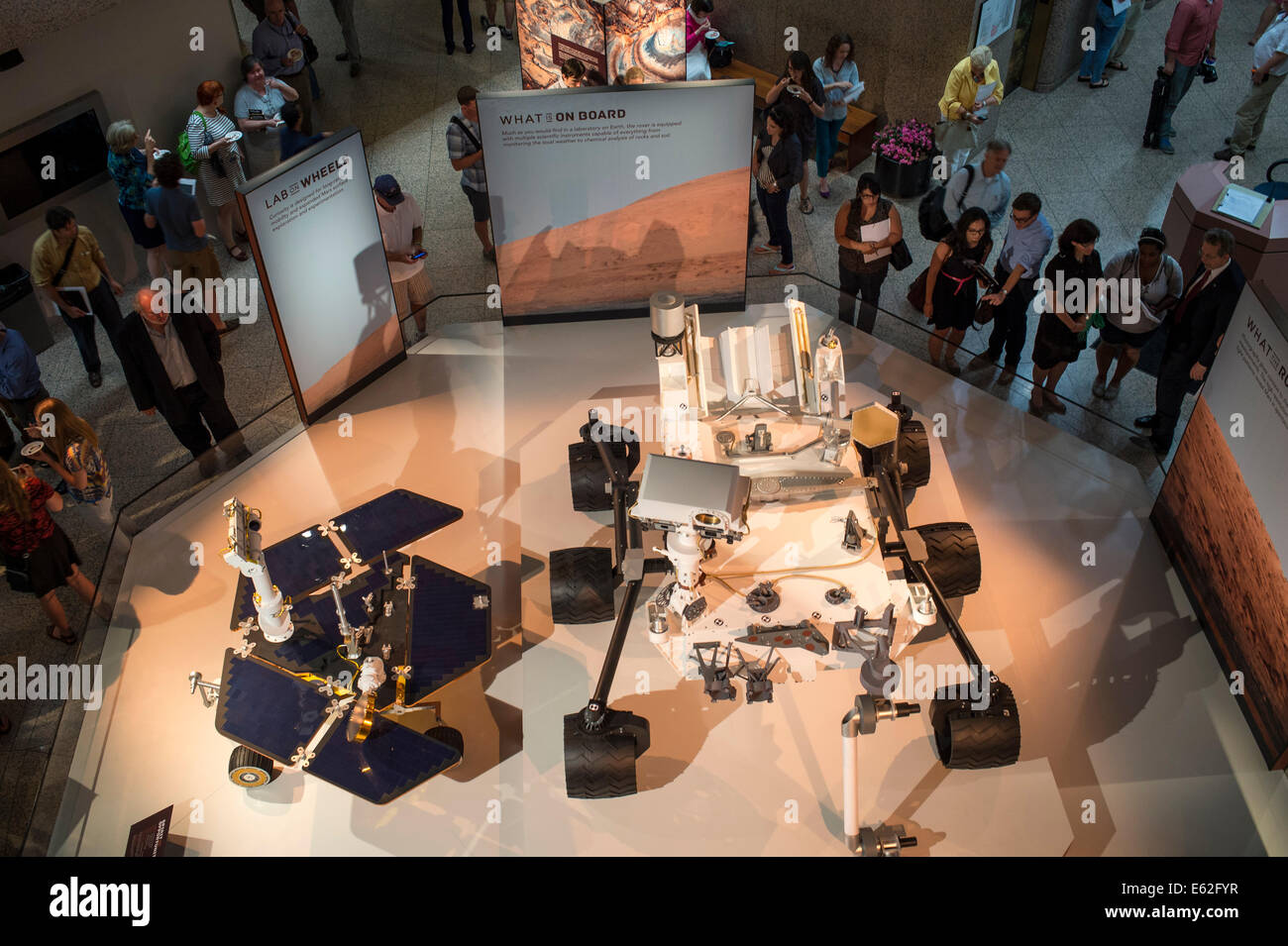 Guest attending the National Geographic “Mars Up Close” panel discussion, look at full scale models of the Spirit/Opportunity, left, and Curiosity, Mars rovers, Tuesday, August 5, 2014, at the National Geographic Society headquarters in Washington. Guest Stock Photo