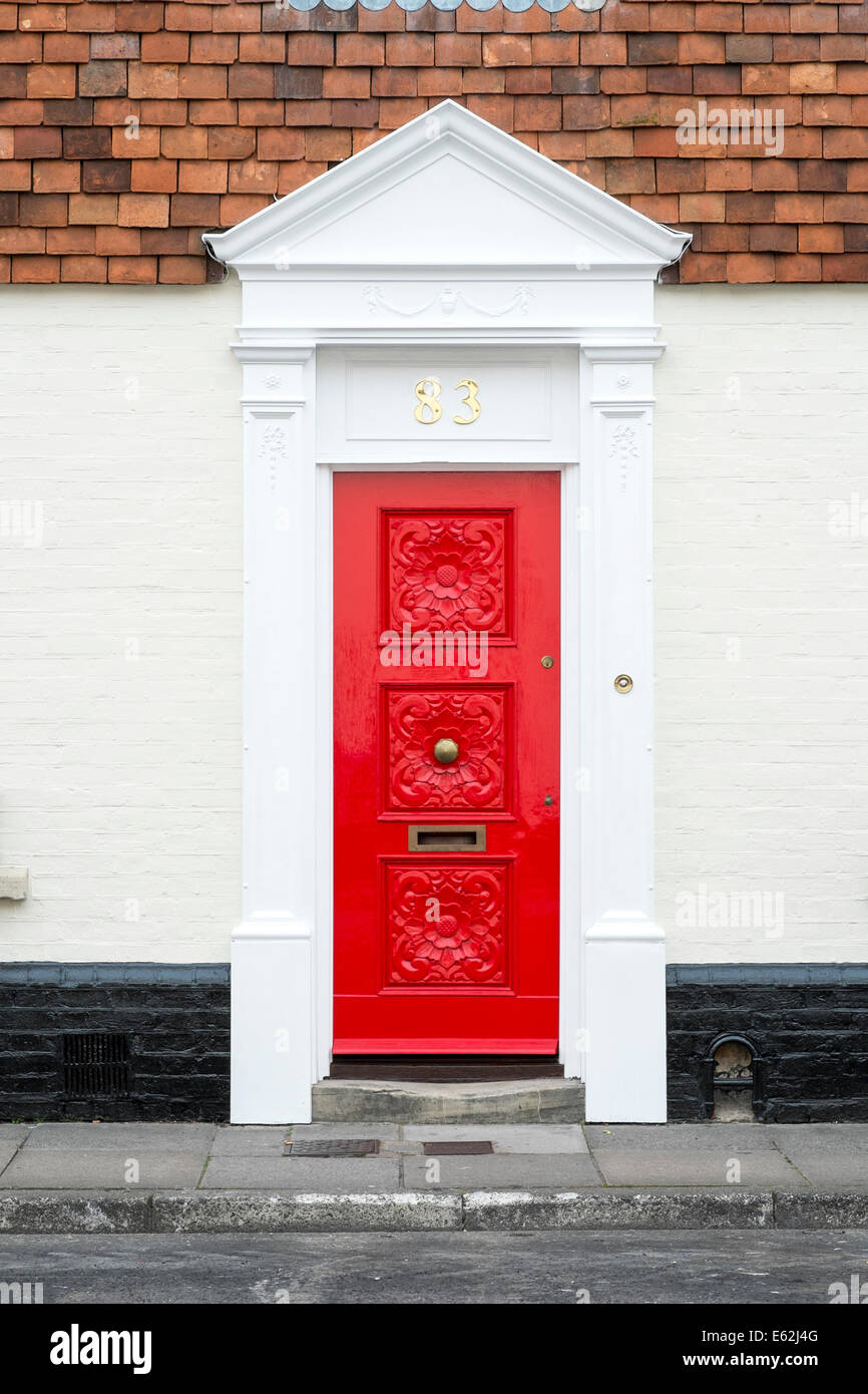 Ornate red front door to UK house Stock Photo