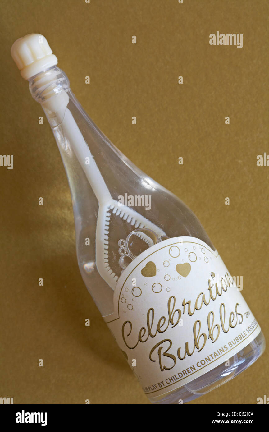 bottle of wedding celebration bubbles on gold background Stock Photo