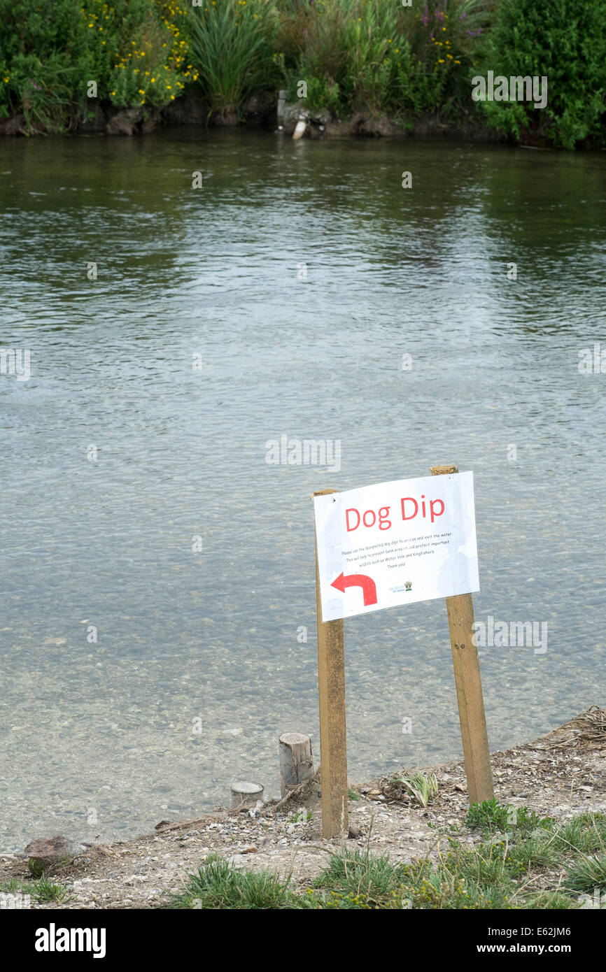 Dog dip sign indicating point at which dogs can enter a river at a site of special scientific interest SSSI Stock Photo