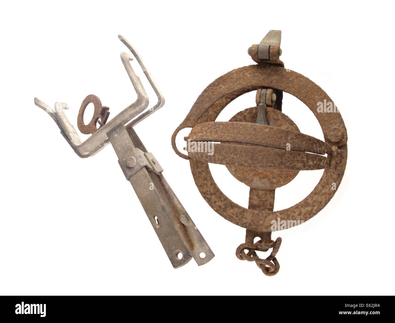 Close up photo of two old and rusty vermin traps on a white background. Stock Photo