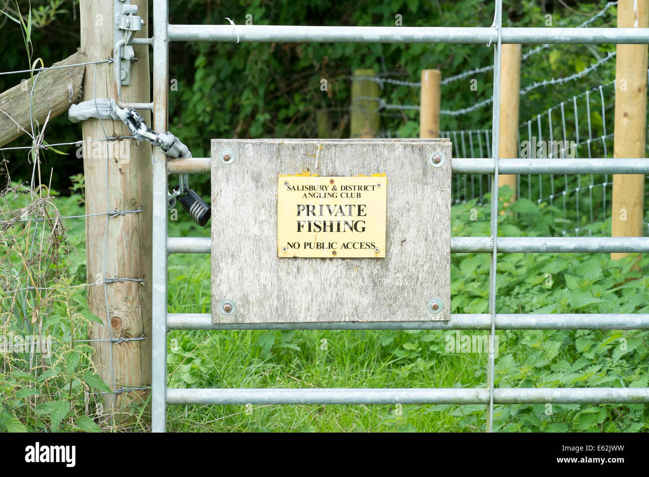 Small private fishing sign on a locked metal gate Stock Photo