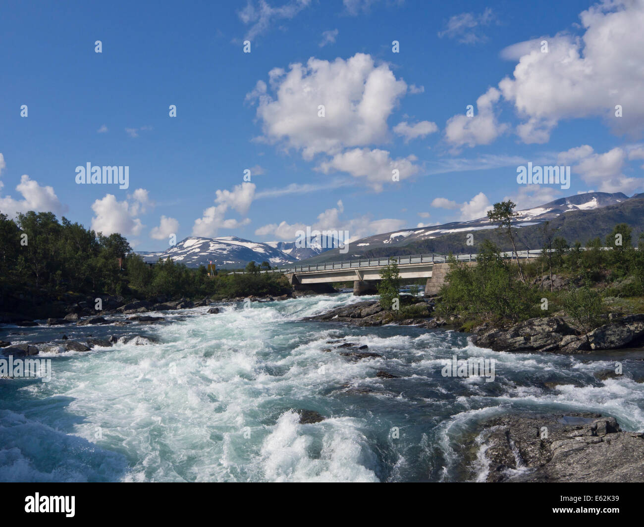 Road bridge crossing river with glacier blue , fresh water, summer mountain scene, Jotunheimen Norway Stock Photo