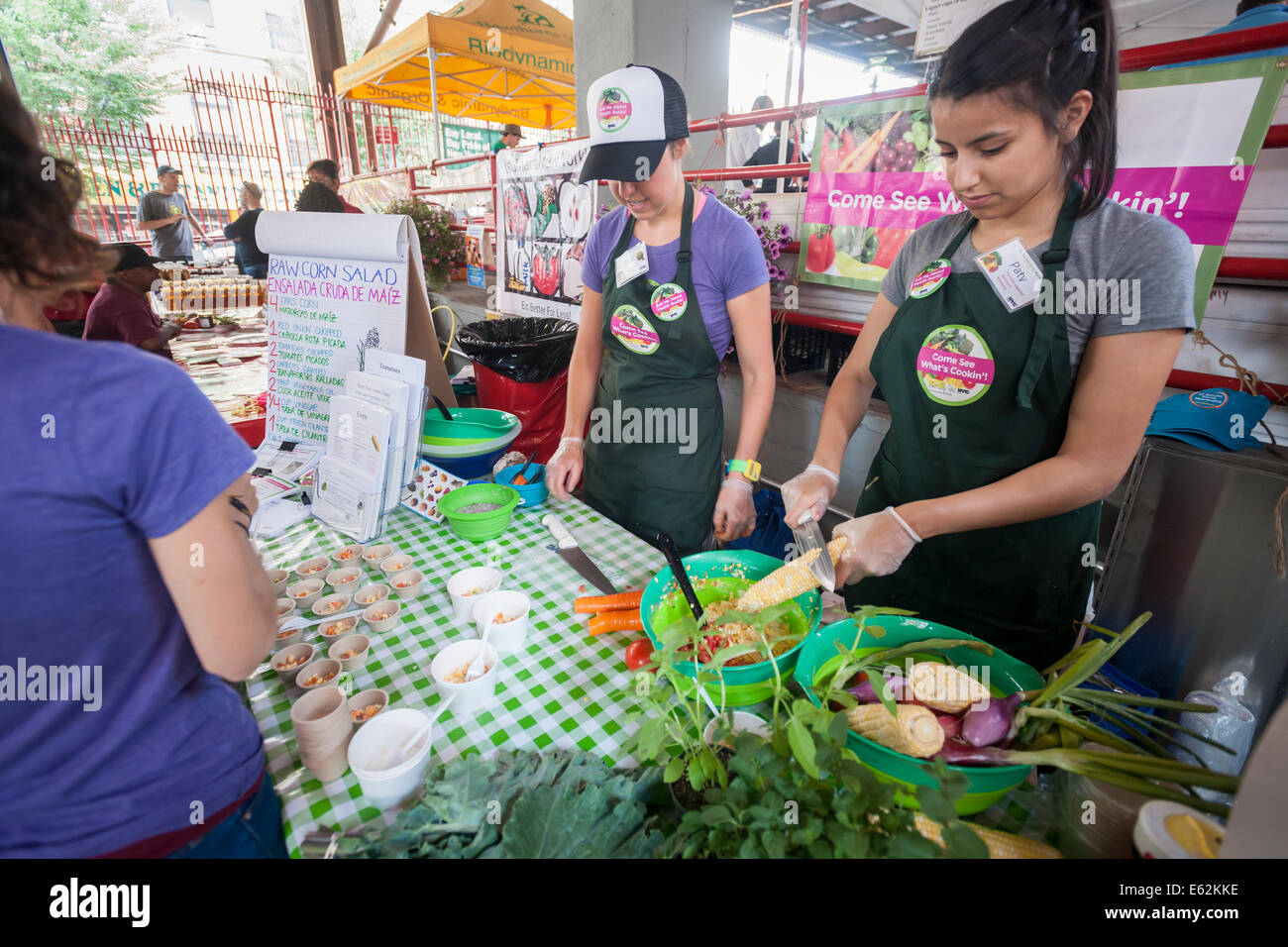 Teens prepare raw corn salad during the reopening of La Marqueta in
