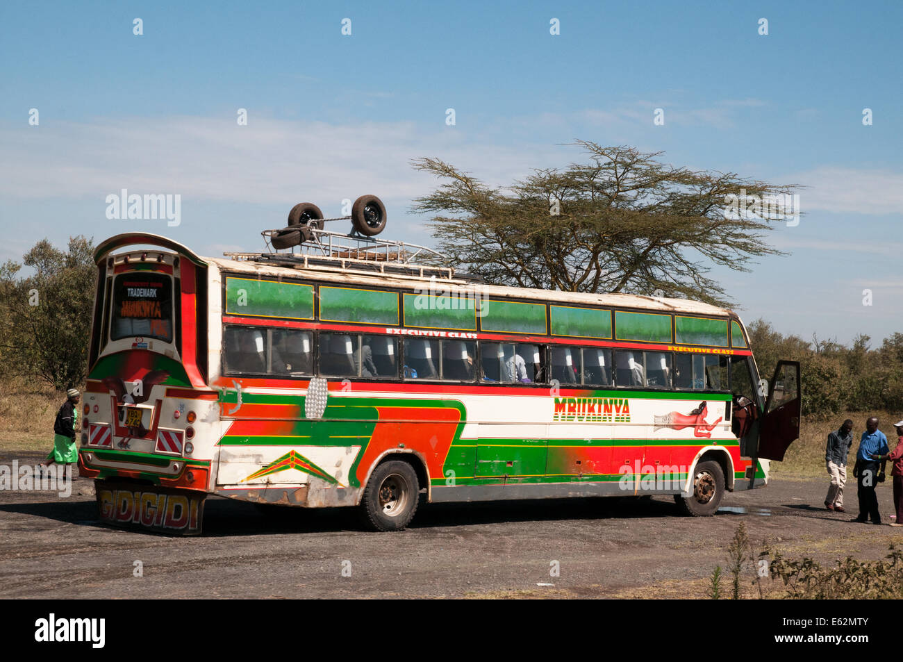 Broken down single decker bus long distance coach with driver outside worrying on Naivasha Nakuru road Kenya Africa  BUS COACH B Stock Photo
