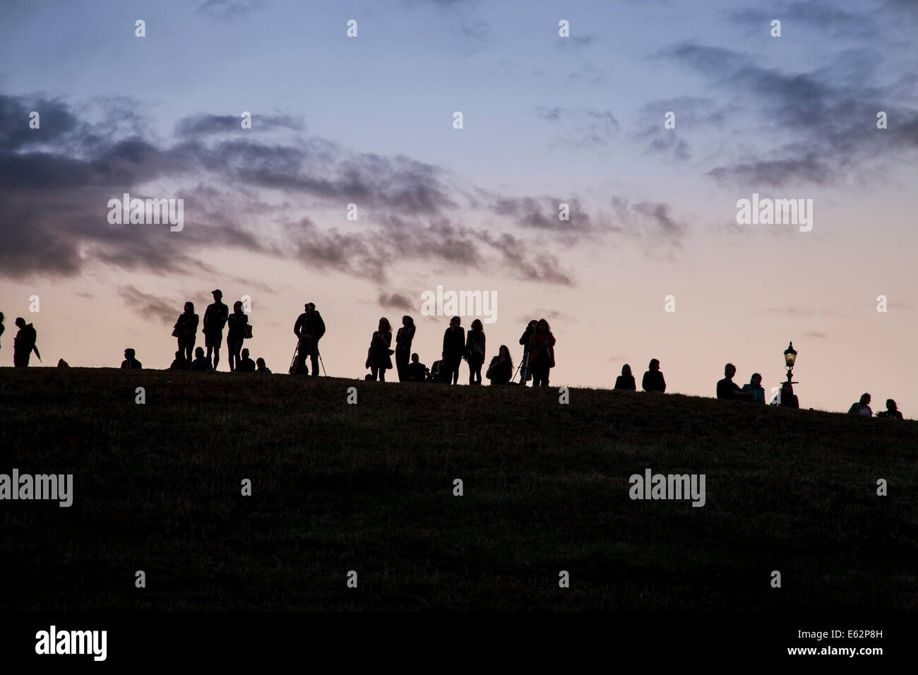 London, England - August 10th, 2014 Crowds watching from Primrose Hill, waiting for the Supermoon to appear Stock Photo