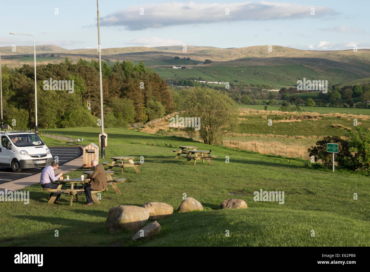 Tebay Services, south Cumbria - award winning M6 motorway services, restaurant and farm shop. Having a coffee in evening sun. Stock Photo