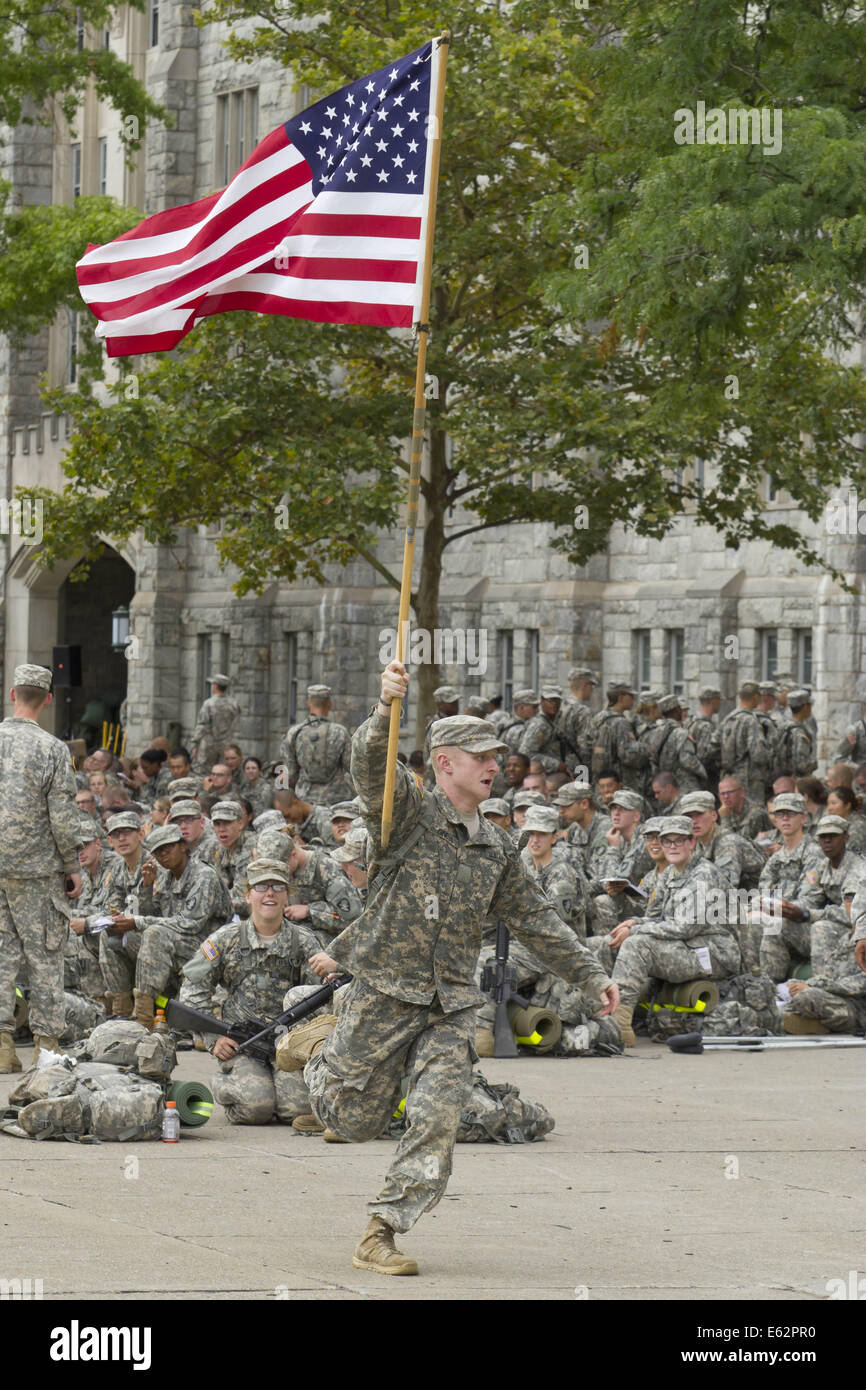 West Point, New York, USA. 12th Aug, 2014. New cadets watch a cadet running with an American flag after marching back from Beast Barracks at Camp Buckner to the United States Military Academy at West Point, New York. The 12-mile march back to West Point marked the end of Cadet Basic Training for the Class of 2018. Credit:  Tom Bushey/ZUMA Wire/Alamy Live News Stock Photo