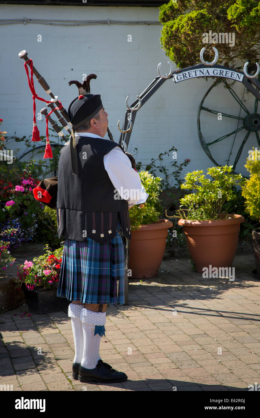 Scottish piper at The Old Blacksmith's Shop in Gretna Green, Dumfries and Galloway, Scotland, UK Stock Photo