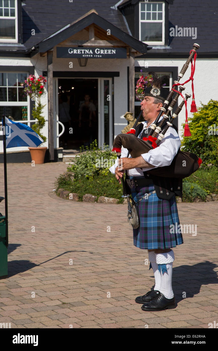 Scottish piper at The Old Blacksmith's Shop in Gretna Green, Dumfries and Galloway, Scotland, UK Stock Photo