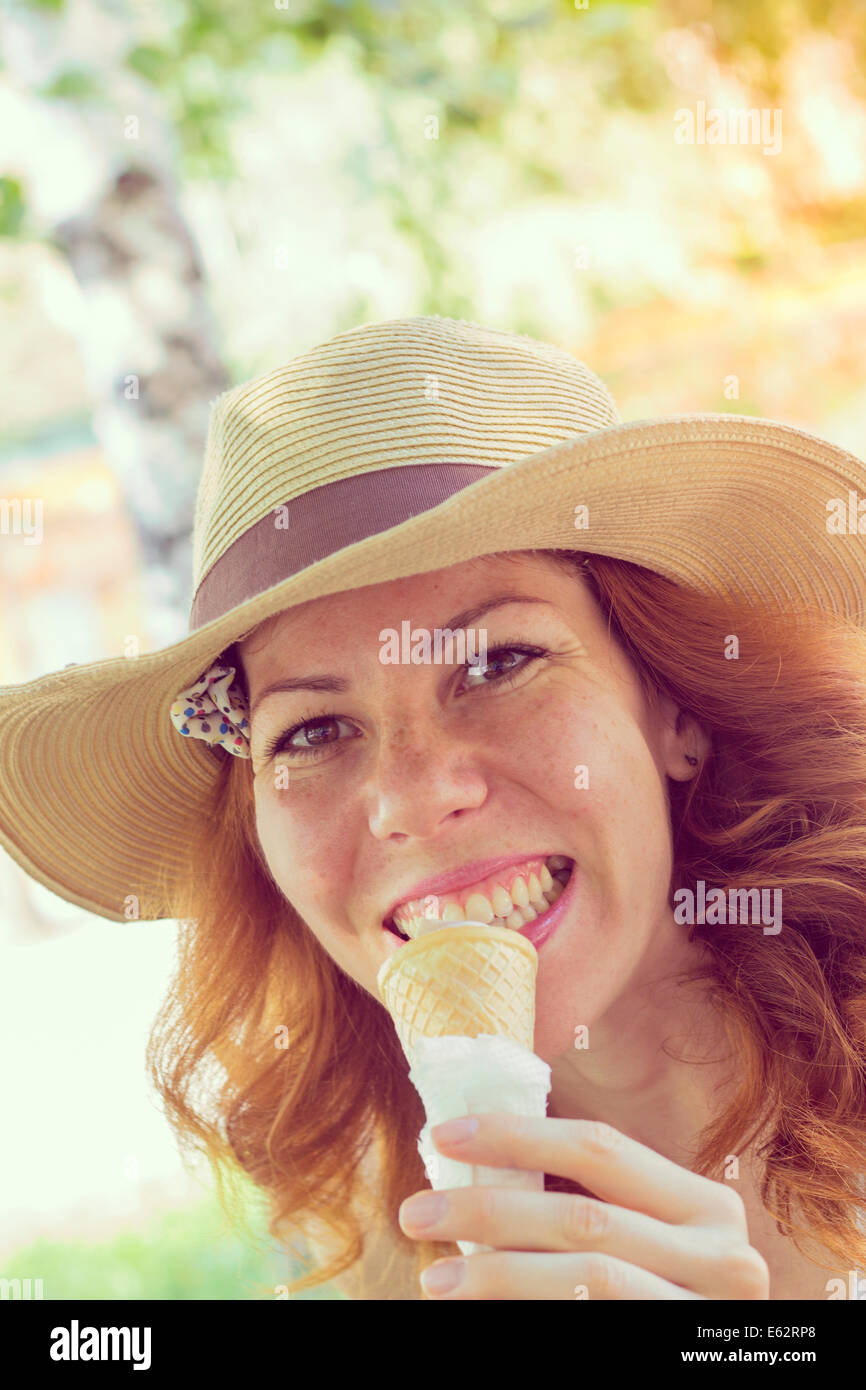 Beautiful Girl eating ice cream cone, close up. Retro style imagery Stock Photo
