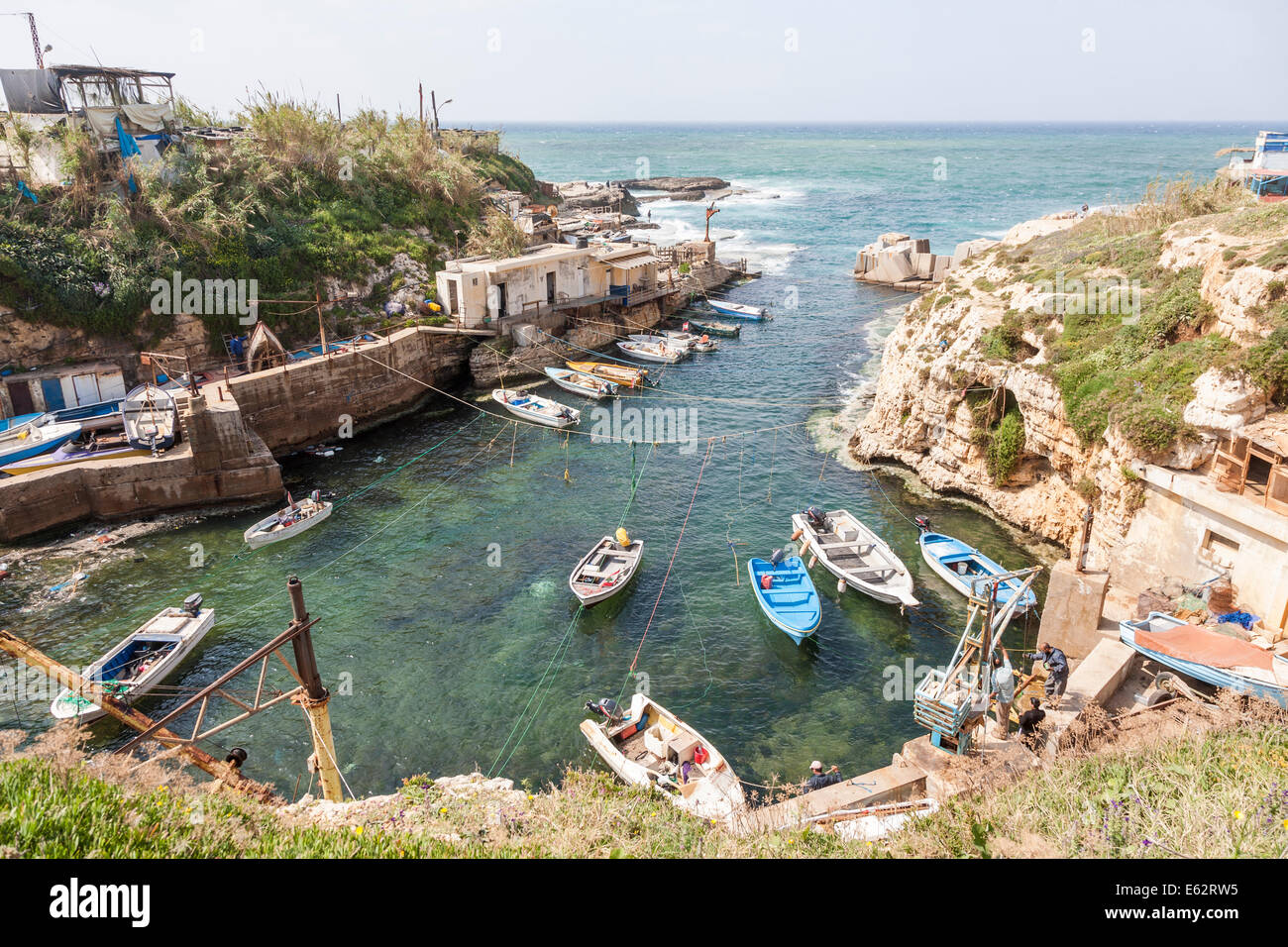 A small fishing village community and harbour on the Mediterranean coast, with moored boats