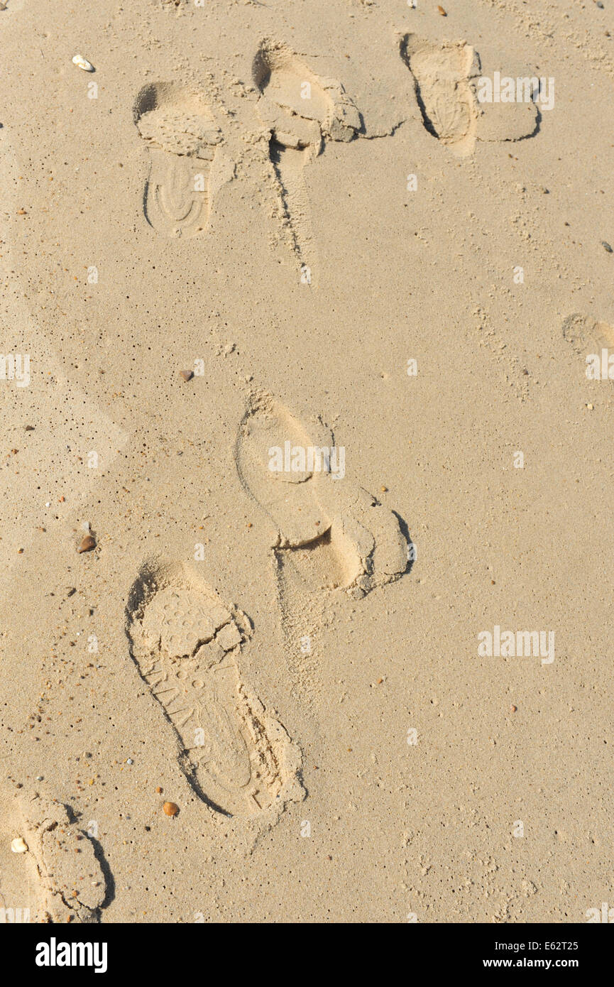 Footprints of shoe shoes in sand on a beach two peoples footprint Stock Photo