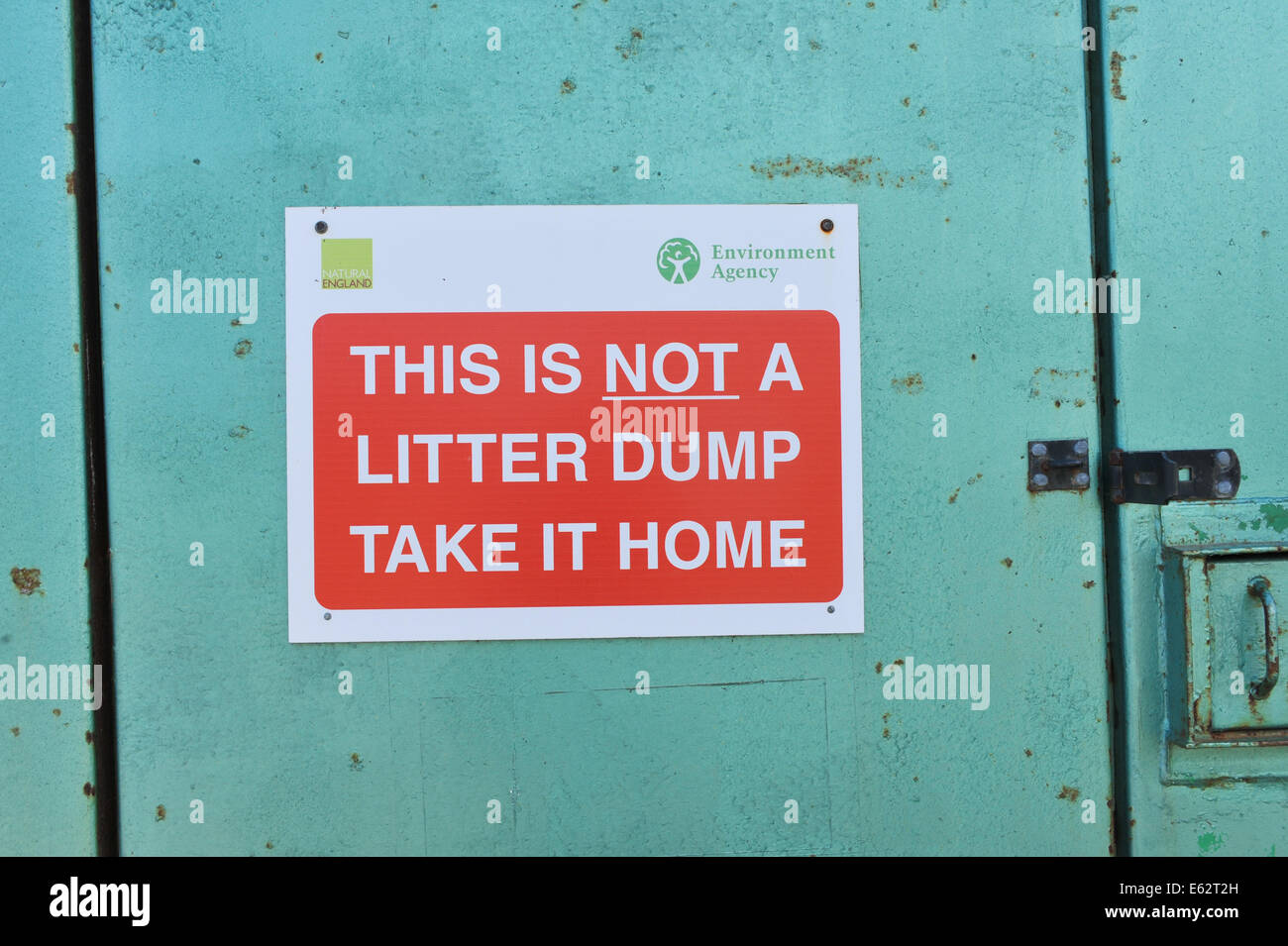 Litter sign on a door take litter home Stock Photo