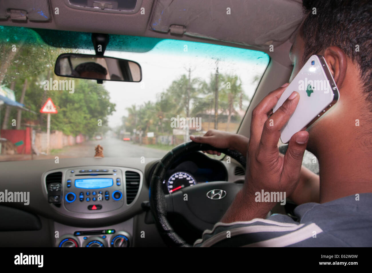 Driving and talking on mobile cell phone Stock Photo