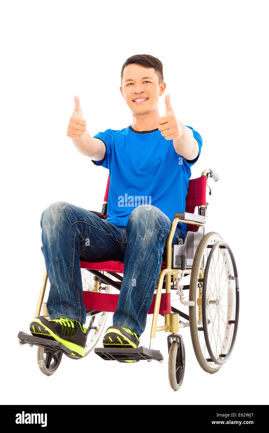 happy young man sitting on a wheelchair and thumb up Stock Photo