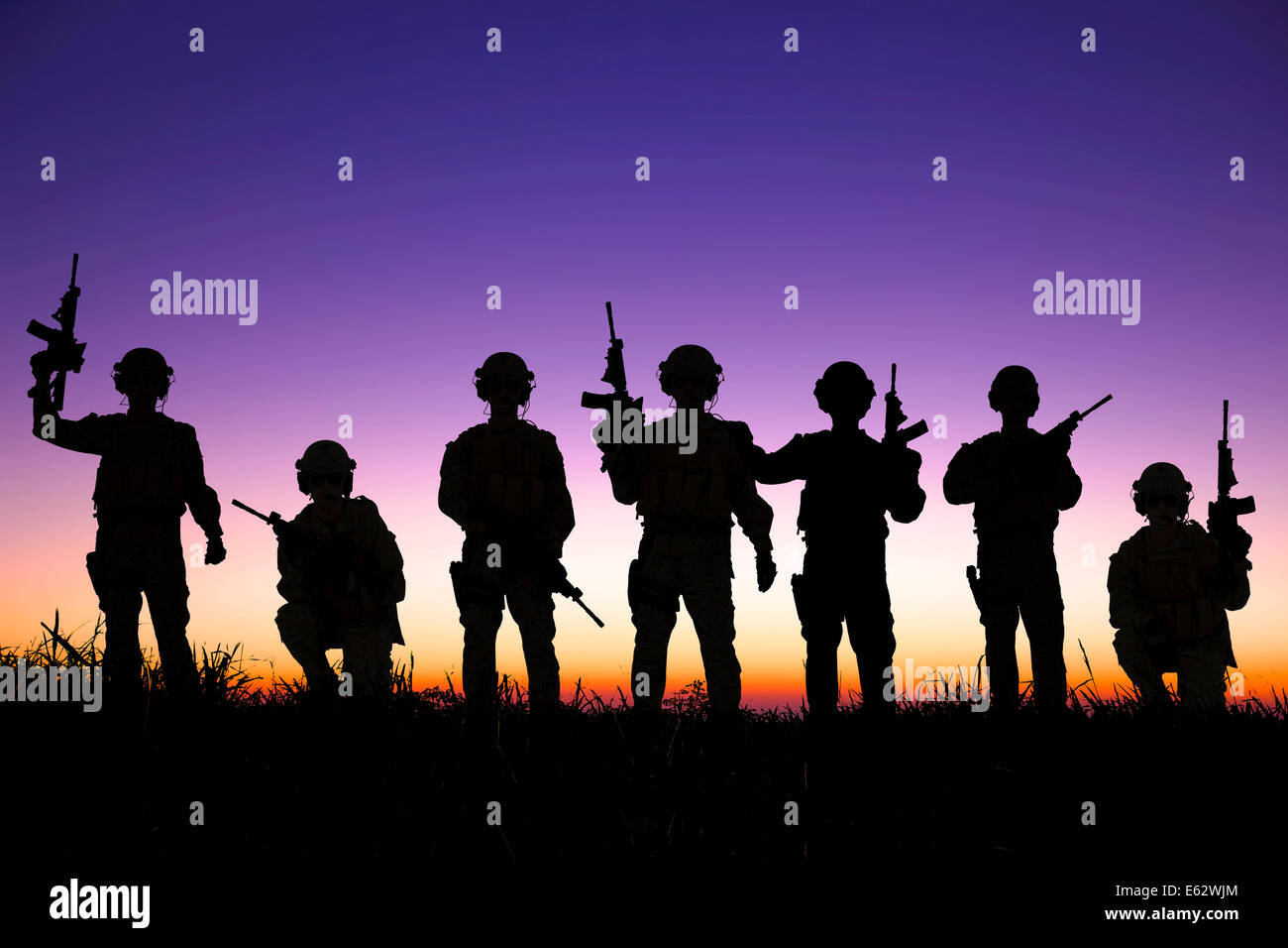 silhouette of  Soldiers team with sunrise background Stock Photo