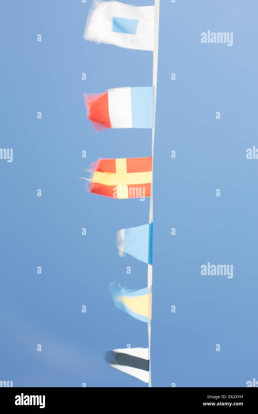 Nautical flags on a boat fluttering in the breeze, Cannes, France Stock Photo